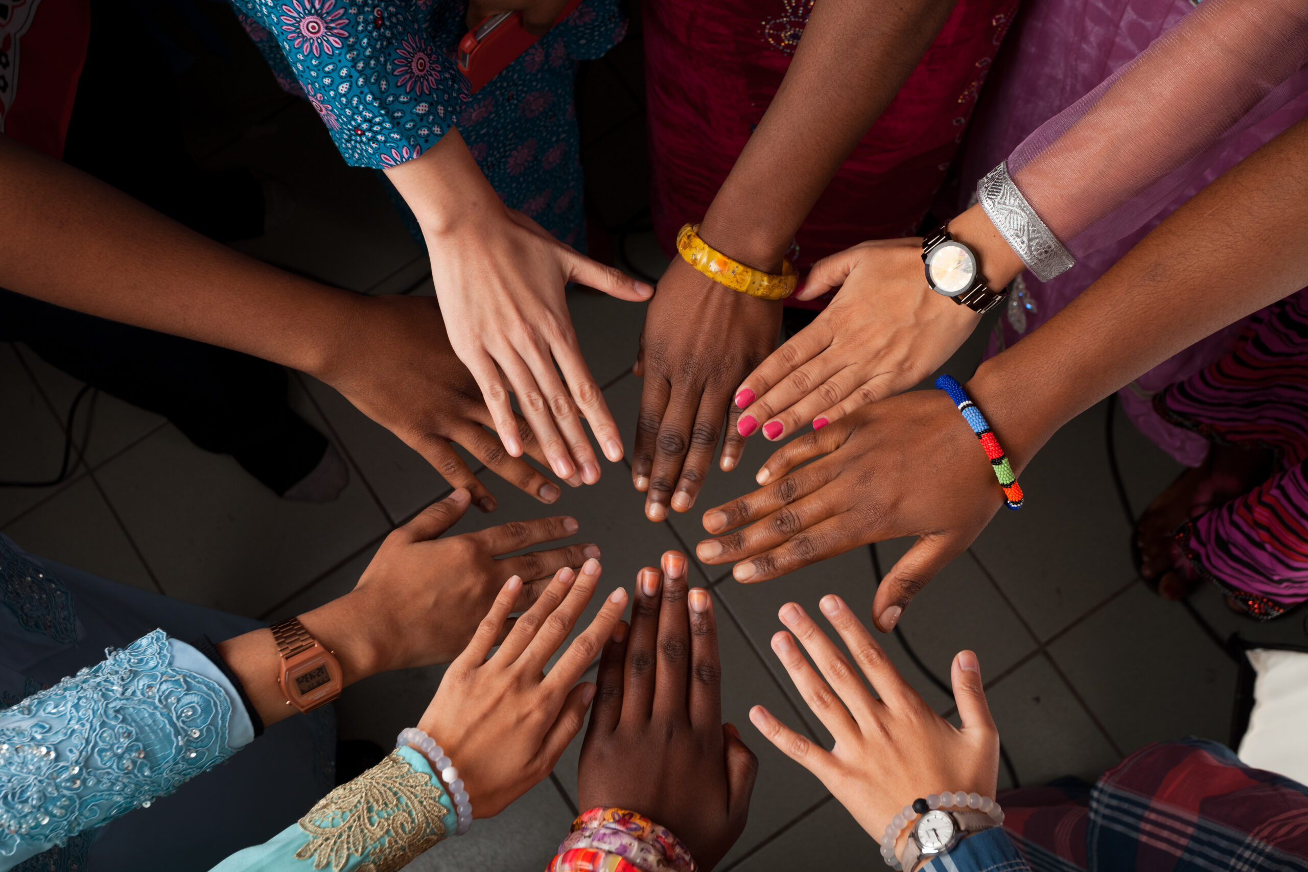 Hands of happy group of African people which stay together in circle