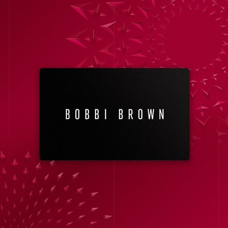 Animation of Bobbi Brown gift cards stacking in a spiral, in front of a red, festive background